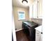 Functional laundry room with modern washer and dryer, cabinets, and counter space at 625 Huiet Dr, Mcdonough, GA 30252