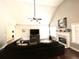 Bright living room with vaulted ceiling, fan, fireplace, and large sectional sofa offers a cozy and inviting space at 625 Huiet Dr, Mcdonough, GA 30252