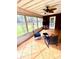 The sunroom has tile floors and a ceiling fan and views to the backyard at 625 Huiet Dr, Mcdonough, GA 30252
