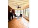 The sunroom has tile floors and a ceiling fan and views to the backyard at 625 Huiet Dr, Mcdonough, GA 30252