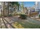 Large backyard with a patio, green lawn, and mature trees, ideal for outdoor enjoyment at 120 Pine Mist Cir, Alpharetta, GA 30022