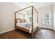 Bedroom with four poster bed, hardwood floors and windows at 120 Pine Mist Cir, Alpharetta, GA 30022