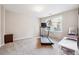 Carpeted bedroom with treadmill and side table at 120 Pine Mist Cir, Alpharetta, GA 30022