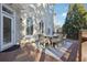 Exterior view of the deck with a dining table, chairs, and arched windows at 120 Pine Mist Cir, Alpharetta, GA 30022