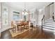 Dining room with hardwood floors, natural light, and a classic chandelier at 120 Pine Mist Cir, Alpharetta, GA 30022