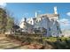 Back exterior showcasing the multi-level deck with multiple chimneys and mature trees at 120 Pine Mist Cir, Alpharetta, GA 30022