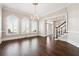 A bright foyer with hardwood floors, crown molding, staircase, and a chandelier at 120 Pine Mist Cir, Alpharetta, GA 30022