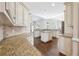 Spacious kitchen featuring white cabinets, granite counters, and a central island at 120 Pine Mist Cir, Alpharetta, GA 30022