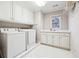 Laundry room with washer, dryer, sink and upper and lower cabinets at 120 Pine Mist Cir, Alpharetta, GA 30022