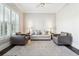 Well-lit living room featuring large windows, and a comfortable seating arrangement at 120 Pine Mist Cir, Alpharetta, GA 30022