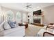 Bright living room featuring a fireplace, hardwood floors, and comfortable seating at 120 Pine Mist Cir, Alpharetta, GA 30022