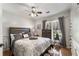 Cozy bedroom features a ceiling fan, wood-look floors, and a window with natural light at 1252 Highfield Dr, Lawrenceville, GA 30043