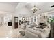 Bright living room with a high ceiling, fireplace, and tiled floors opening to dining area at 1252 Highfield Dr, Lawrenceville, GA 30043