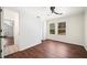 Hardwood floored bedroom with two windows and ceiling fan at 1891 W Forrest Ave, Atlanta, GA 30344