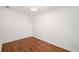 Bright, minimalist bedroom with wood floors and neutral walls at 1891 W Forrest Ave, Atlanta, GA 30344