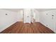 Bedroom with multiple closet doors, white trim, and wood flooring at 1891 W Forrest Ave, Atlanta, GA 30344