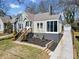 Lovely home featuring an enclosed porch and an expansive driveway leading to a detached garage at 1891 W Forrest Ave, Atlanta, GA 30344