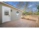 Home exterior featuring a wooden deck, side entry door, and updated siding at 1891 W Forrest Ave, Atlanta, GA 30344