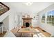 Sun-drenched living room featuring hardwood floors, a stone fireplace, and built-in bookshelves at 1891 W Forrest Ave, Atlanta, GA 30344