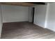 Clean, empty basement space with wood look flooring and white walls at 2791 Allegro Nw Dr, Atlanta, GA 30318