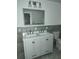 Bathroom with gray tiled walls, double vanity sink, and a large framed mirror at 2791 Allegro Nw Dr, Atlanta, GA 30318