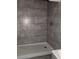 Stylish shower with gray tiled walls and modern fixtures at 2791 Allegro Nw Dr, Atlanta, GA 30318