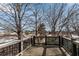 Wooden balcony with black iron railing, overlooking trees and neighborhood buildings at 2880 Stonehall Ct # 2, Atlanta, GA 30339