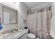 Bathroom featuring a granite countertop, framed mirror, and shower-tub combo at 2880 Stonehall Ct # 2, Atlanta, GA 30339