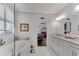 Primary bathroom with soaking tub, white vanity with granite countertop, and view to bedroom at 2880 Stonehall Ct # 2, Atlanta, GA 30339