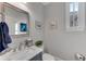 Elegant powder room featuring marble countertop, modern fixtures, and decorative wall art at 2880 Stonehall Ct # 2, Atlanta, GA 30339