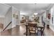 Open dining area with hardwood floors connecting to kitchen and a view of the staircase at 2880 Stonehall Ct # 2, Atlanta, GA 30339