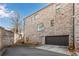 Brick exterior of the home with a two-car garage and adjacent parking area at 2880 Stonehall Ct # 2, Atlanta, GA 30339