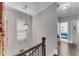 Upstairs hallway with chandelier and window with blinds at 2880 Stonehall Ct # 2, Atlanta, GA 30339