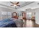 Bright primary bedroom featuring tray ceilings, dark wood floors, and sitting area at 2880 Stonehall Ct # 2, Atlanta, GA 30339