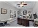 Bright office with large window, neutral walls, ceiling fan, and glass-topped, dark wood desk at 2880 Stonehall Ct # 2, Atlanta, GA 30339