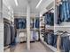 Organized walk-in closet with custom shelving and hanging rods for clothes and accessories at 2880 Stonehall Ct # 2, Atlanta, GA 30339