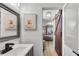 Stylish bathroom with a sliding barn door and unique Highland Cow art prints at 3655 Habersham Ne Rd # B148, Atlanta, GA 30305