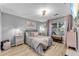 Bedroom with light grey walls, soft pink accents, and a lovely chandelier at 3655 Habersham Ne Rd # B148, Atlanta, GA 30305