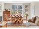 Sunlit dining area with wooden table, seating for six, and a view of the surrounding neighborhood at 3655 Habersham Ne Rd # B148, Atlanta, GA 30305