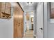 Hallway view with access to the bathroom, featuring built-in coat racks and white trim at 3655 Habersham Ne Rd # B148, Atlanta, GA 30305