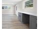 Basement area featuring modern flooring, a countertop desk, a window and access to the outside at 1120 Taliwa Ne Trl, Marietta, GA 30068