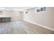 Basement area featuring modern flooring, a countertop desk, and multiple windows at 1120 Taliwa Ne Trl, Marietta, GA 30068