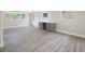 Basement area featuring modern flooring, a countertop desk, and two large windows at 1120 Taliwa Ne Trl, Marietta, GA 30068