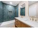 Beautiful bathroom featuring blue tiled walls, double sink vanity, and framed mirrors at 1120 Taliwa Ne Trl, Marietta, GA 30068