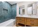 Stylish bathroom with blue tiled walls, double sink vanity, and framed mirrors at 1120 Taliwa Ne Trl, Marietta, GA 30068
