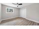 Neutral bedroom with a ceiling fan, large window, and hardwood style floors at 1120 Taliwa Ne Trl, Marietta, GA 30068