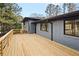 Rear of home showing a large wooden deck and a grey painted brick exterior at 1120 Taliwa Ne Trl, Marietta, GA 30068
