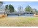 Full backyard exterior view of this grey painted home with a large grassy area at 1120 Taliwa Ne Trl, Marietta, GA 30068