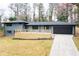 Exterior of home featuring a wooden deck, driveway, and attached garage at 1120 Taliwa Ne Trl, Marietta, GA 30068