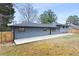 Rear exterior view of this home with a large concrete patio area and natural wood fence at 1120 Taliwa Ne Trl, Marietta, GA 30068